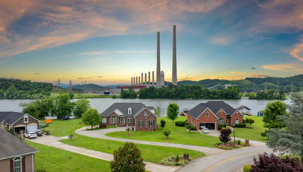 Neighborhood next to a thermal plant at sunset
